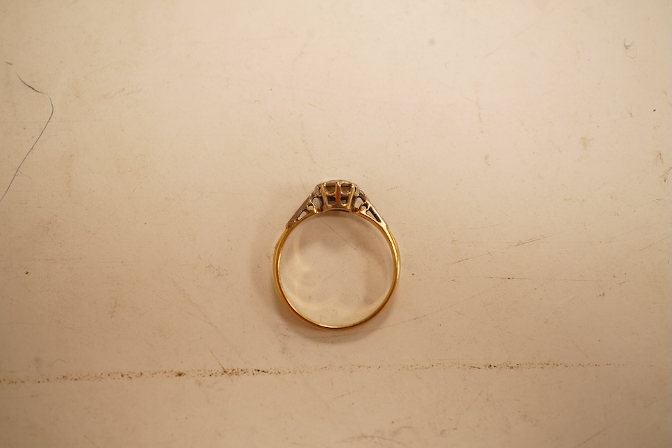 A modern yellow metal and single stone diamond set ring, with baguette and round cut diamond cluster set shoulders, total diamond weight approx. 0.50ct, size J/K (sizing spheres), gross weight 4.6 grams.